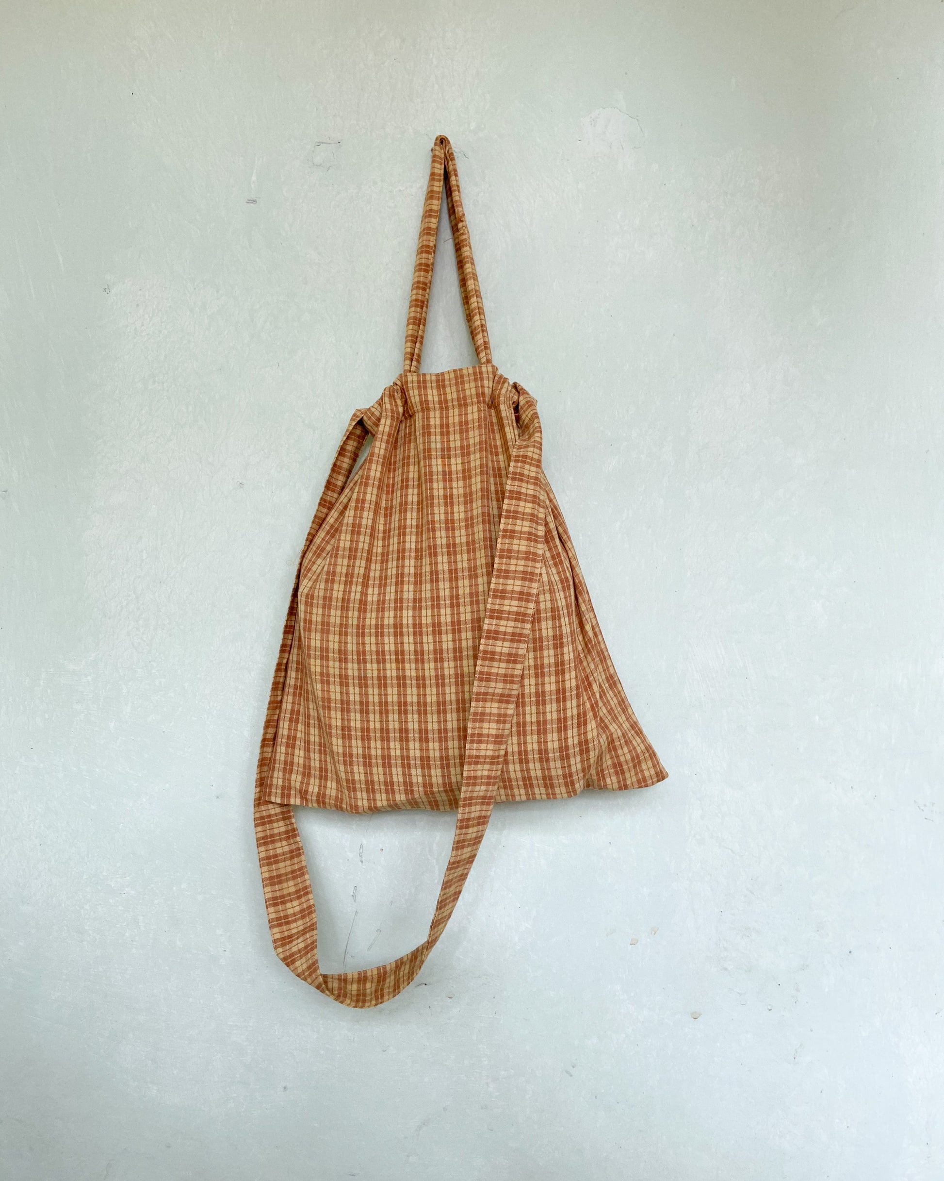 Back side of a checks bag hanging on the wall